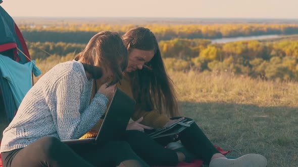 Girl with Laptop Looks at Friend Tablet in Camp Slow Motion