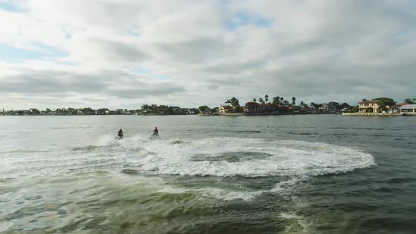 Two wave runners moving very fast under a cloudy sky