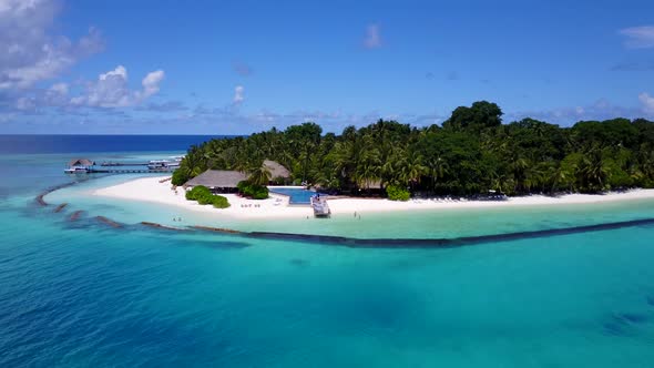 Beautiful drone travel shot of a white sand paradise beach and aqua blue ocean background 