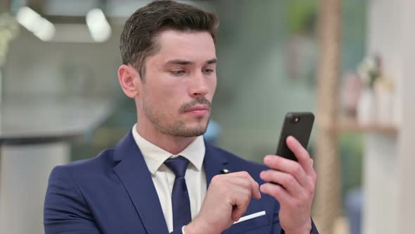 Attractive Young Businessman Using Smartphone 