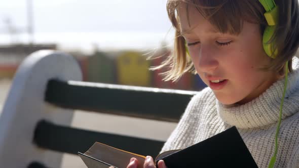 Girl reading a book at beach