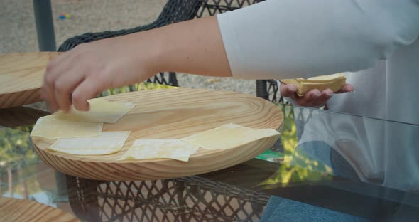 Woman Hands Closeup Making Chinese Food Wonton Outdoors with Meat and Dough