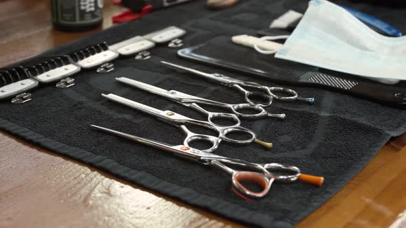 Barber Takes Scissors From a Full Tool Board Slow Motion