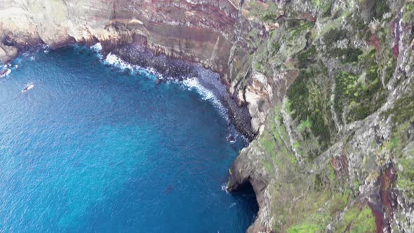 Steep rugged coastline in Azores Archipelago - Tilt up aerial shot