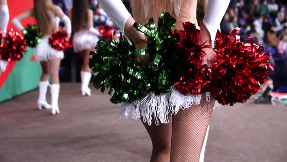 Cheerleader in White Suit with Tinsel Skirt Dances with Team