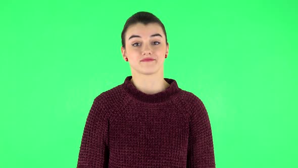 Girl Listens Carefully To Boring Information. Green Screen