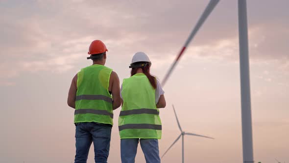 Two Specialist Man and Woman Holding Joystick Controlling Flying Drone Windmills