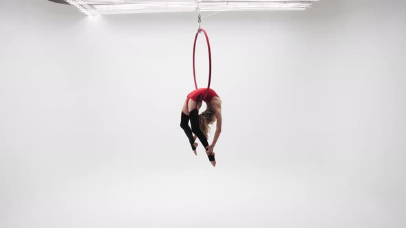 Flexible Girl In Red Spins On A Hoop