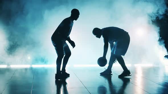 Slow Motion of Two African Men Practicing Basketball Moves