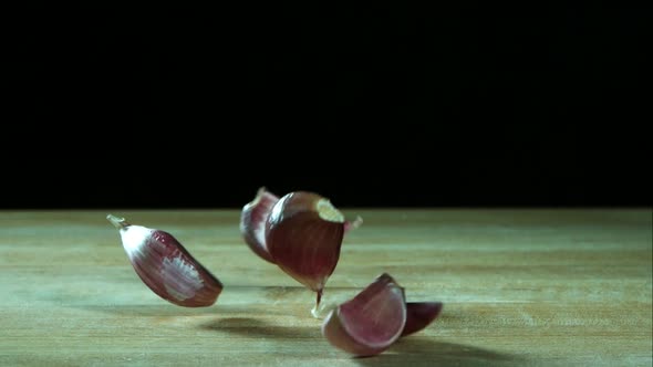 Garlic clove pieces bouncing in ultra slow motion 