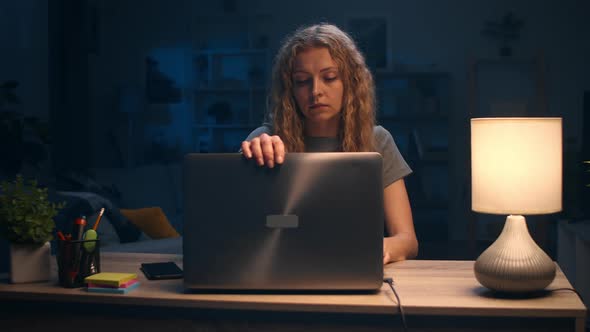 Young Woman Finished Work on Laptop at Home at Night