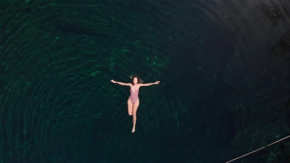 Relaxed woman floating on water in lake