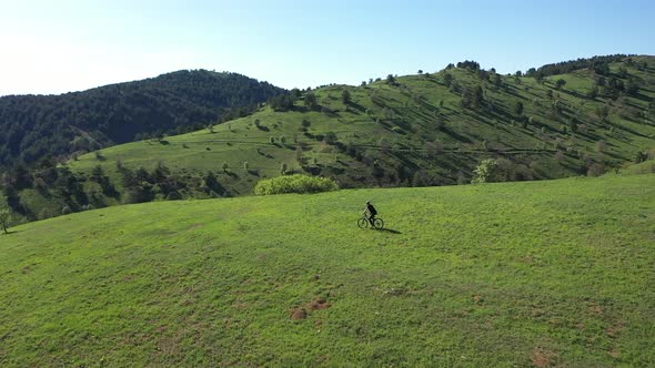 Aerial View Of The Cyclist Ride A Bike In The Green Mountains