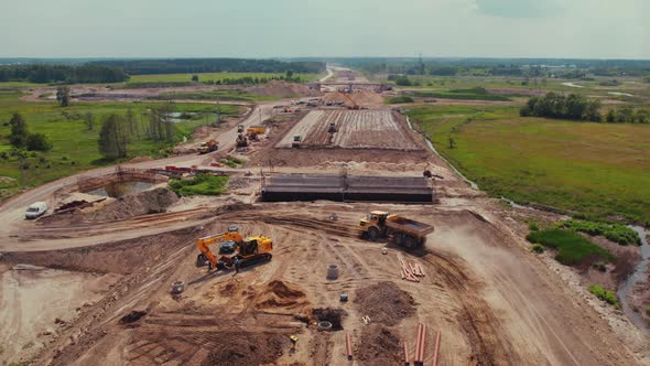 Many Construction Machines Working on a New Highway in the Middle of Nowhere