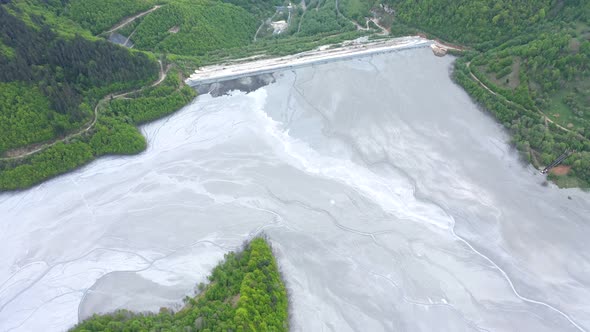 Flying Over a Giant Decanting Lake Full With Mining Waste Residuals Flooding Into a Settling Basin