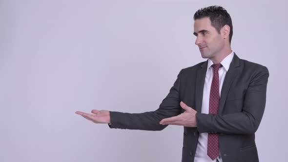 Happy Handsome Businessman Smiling While Showing Something