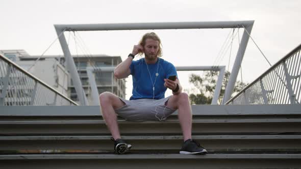 Sporty Caucasian man on a bridge