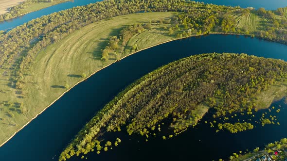 Aerial View Green Forest Woods And Curved River Landscape In Sunny Spring Day