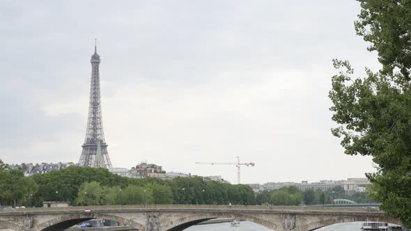 Parisian and French famous Eiffel tower near river Seine by the day slow tilt 4K 2160p 30fps UltraHD