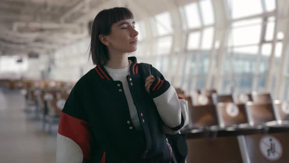 Adorable Female Hipster with Backpack Moving at Airport