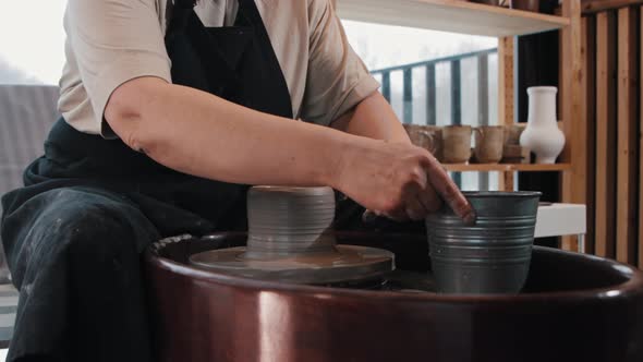 An Elderly Woman Potter Working with a Wheel