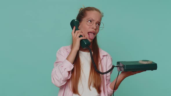 Crazy Teenager Girl Child Kid Talking on Wired Vintage Telephone of 80s Fooling Making Silly Faces