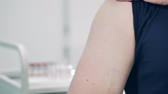 Close Up of Male Arm Getting Injected with a Vaccine