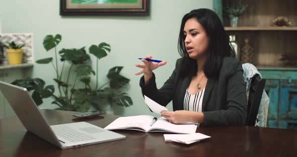 Hispanic Woman Attending Virtual Meeting at Home
