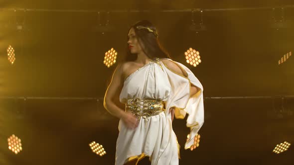 Girl in a Golden Greek Costume Dancing on the Stage of the Theater.