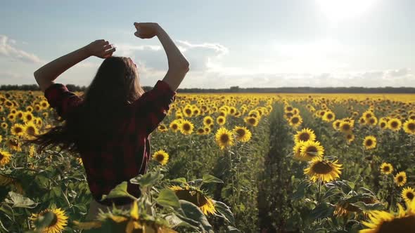 Carefree Happy Woman Running in Sunflower Field