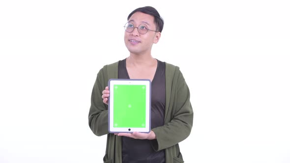 Happy Japanese Man with Eyeglasses Thinking While Showing Digital Tablet
