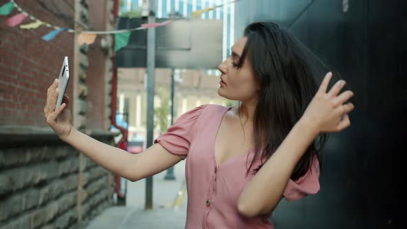 Portrait of Attractive Young Asian Lady Taking Selfie with Smart Phone Camera Outdoors