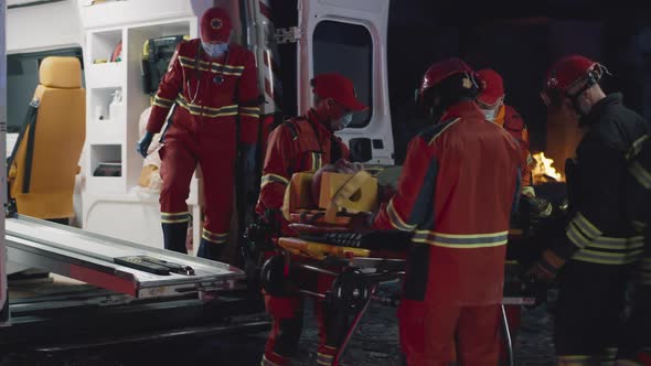 Diverse Paramedics Transporting Patient After Accident