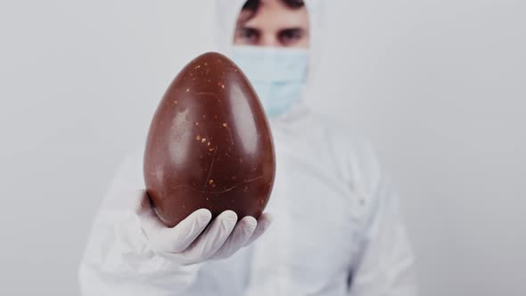 Coronavirus doctor with chocolate easter egg