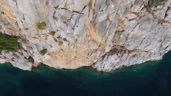 Rocky Steep Wall Cliff by the Seashore in Untouched Sea