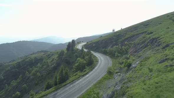 Aerial View of Summer Traffic on Mountain Passae Vehicles on Road Trip