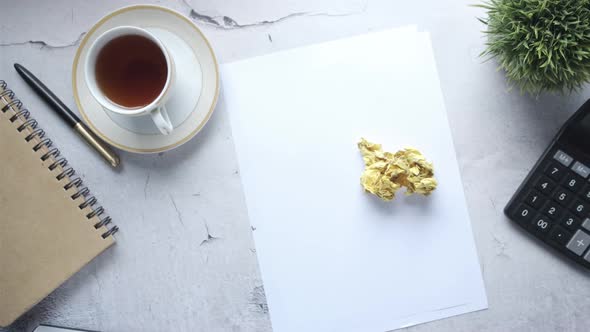 Crumpled Paper Ball and Notepad on Wooden Table