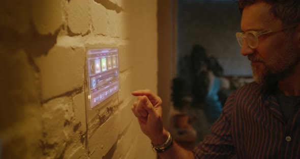 Man Controlling Lighting with Home Hub