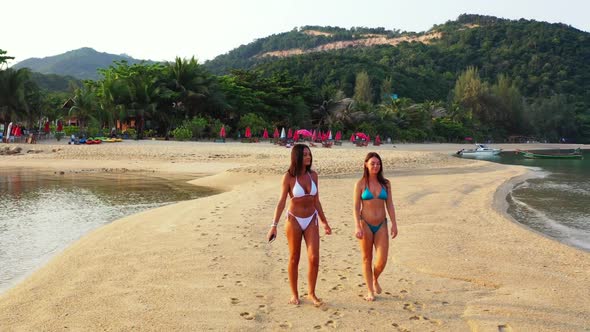 Women happy together on beautiful bay beach break by clear ocean and white sand background of Thaila