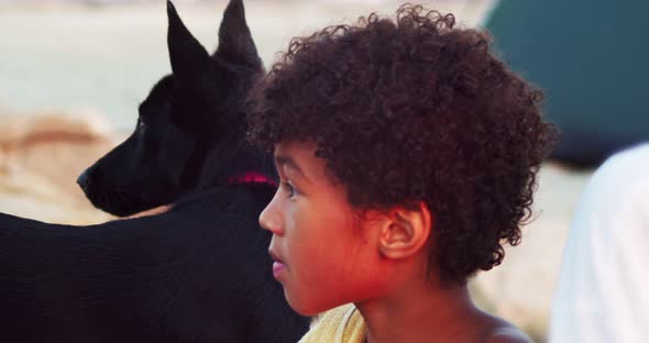 Portrait of a Mulatto Boy and a Black Dog in Profile Children and Animals are Best Friends