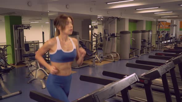 Female Warming Up Before Workout in Sport Club