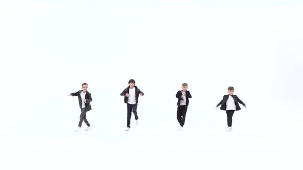 Little Boys Are Dancing a Modern Dance on the White Background in Black Leather Jackets and Jeans