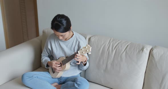 Woman play with ukulele 