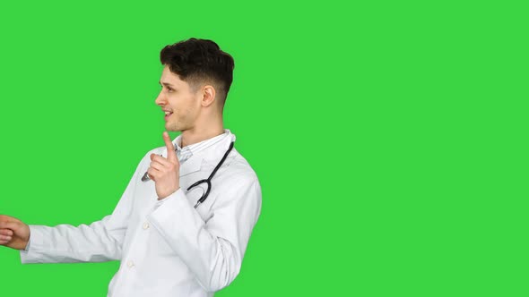 Young Doctor Wearing Lab Coat Dancing on a Green Screen, Chroma Key.