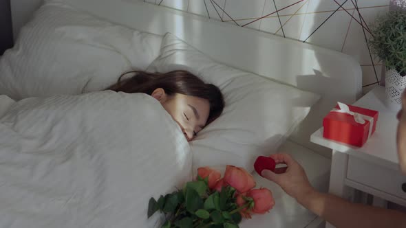 Young Female Woman Sleeping in Bed Man Hands Putting Flowers Red Gift Box Ring