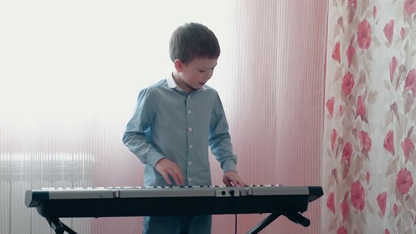 Little Boy Playing on Musical Synthesizer