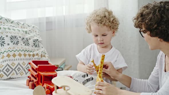 Loving Mother Playing with Toddler Boy