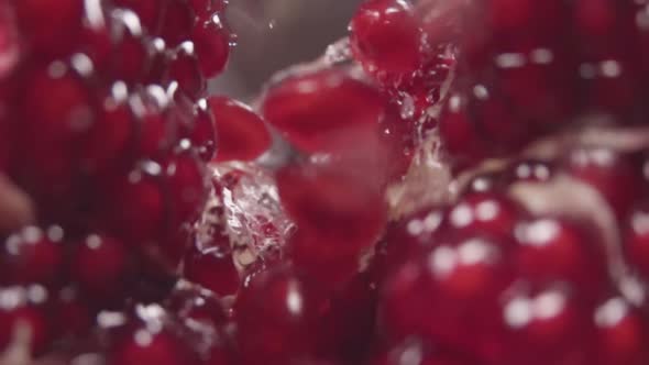 Water Flow Between Pomegranate Grains. Slow Motion