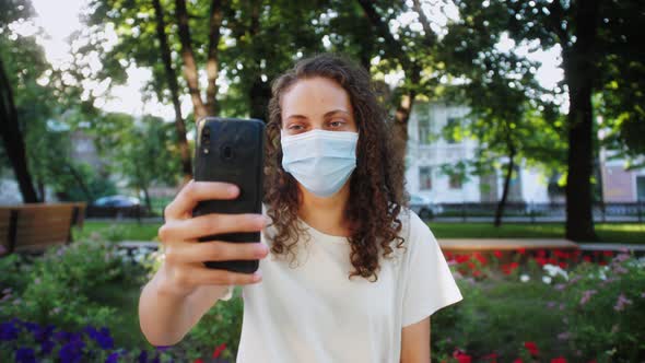 Beautiful Mixed Race Girl Teenager Wearing a Face Mask During COVID19 Coronavirus Pandemic Using