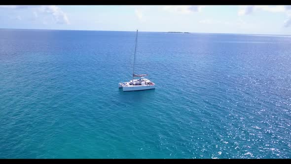 Aerial drone shot seascape of perfect seashore beach holiday by shallow lagoon with clean sandy back